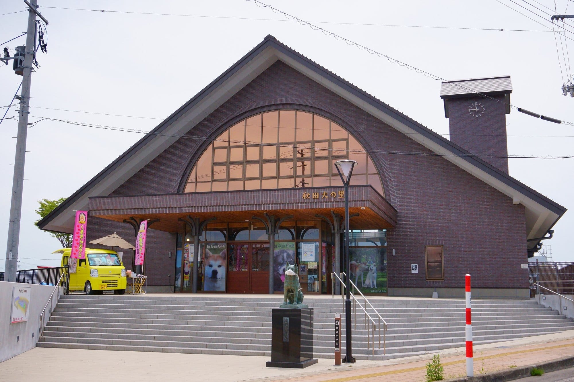 The Akita Dog Visitor Center in Odate, a brick building modelled on the old Shibuya Station, with a Hachiko statue in front