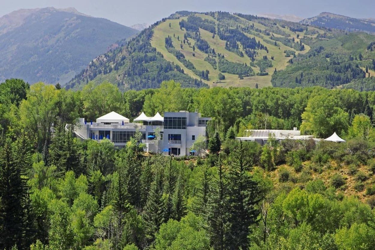 Aspen Meadows Resort among aspen groves below the green ski runs of Aspen Mountain in summer