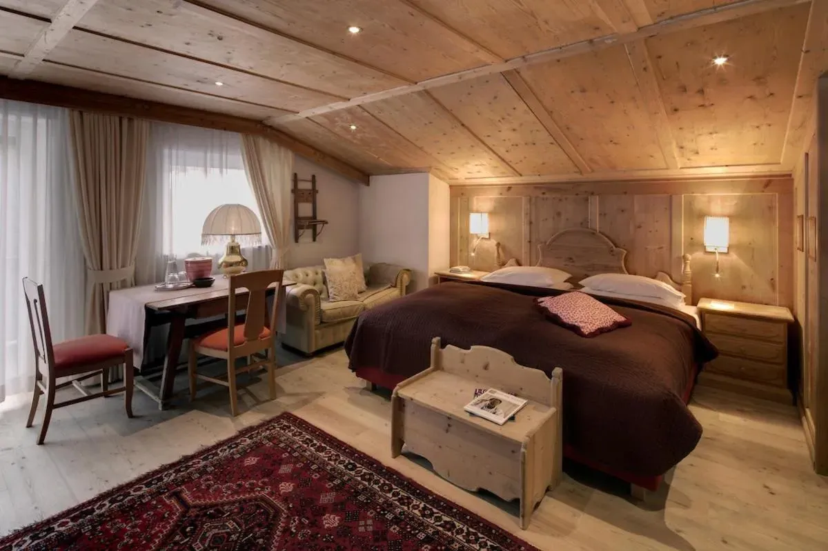A guest room at Hotel La Perla, Corvara