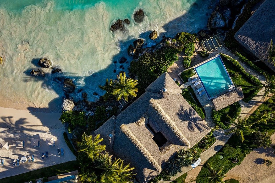 Aerial view of the thatched Oceanfront Bungalows, a private pool and the beach at Eden Roc Cap Cana