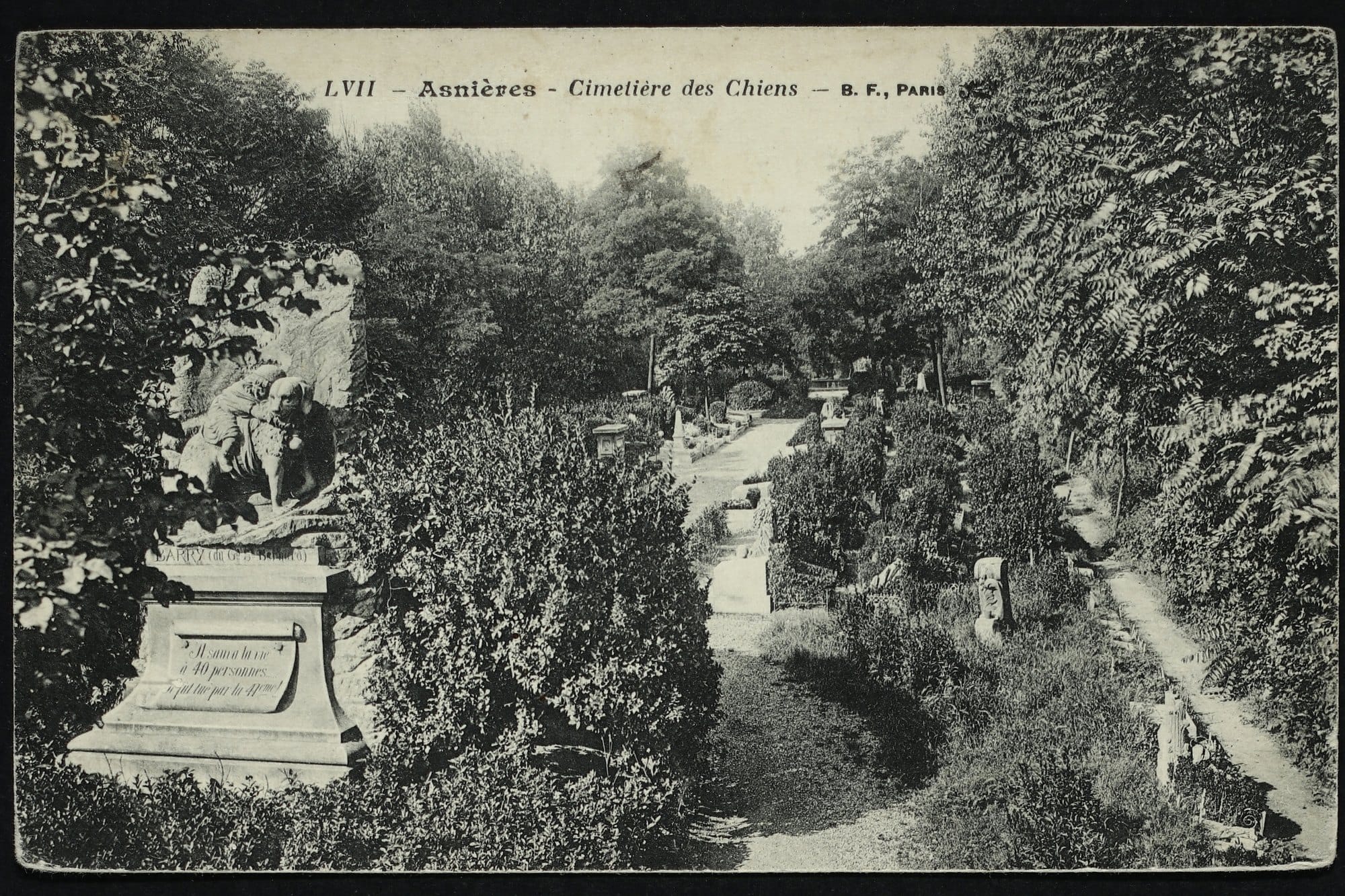 Old postcard of the Barry monument, a St Bernard carrying a child, beside the central path of the dog cemetery at Asnières