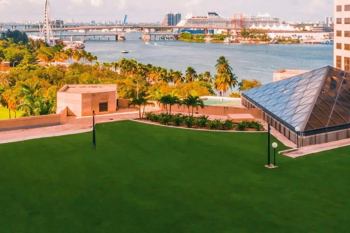 The SkyLawn rooftop green at InterContinental Miami, looking over Biscayne Bay to the port