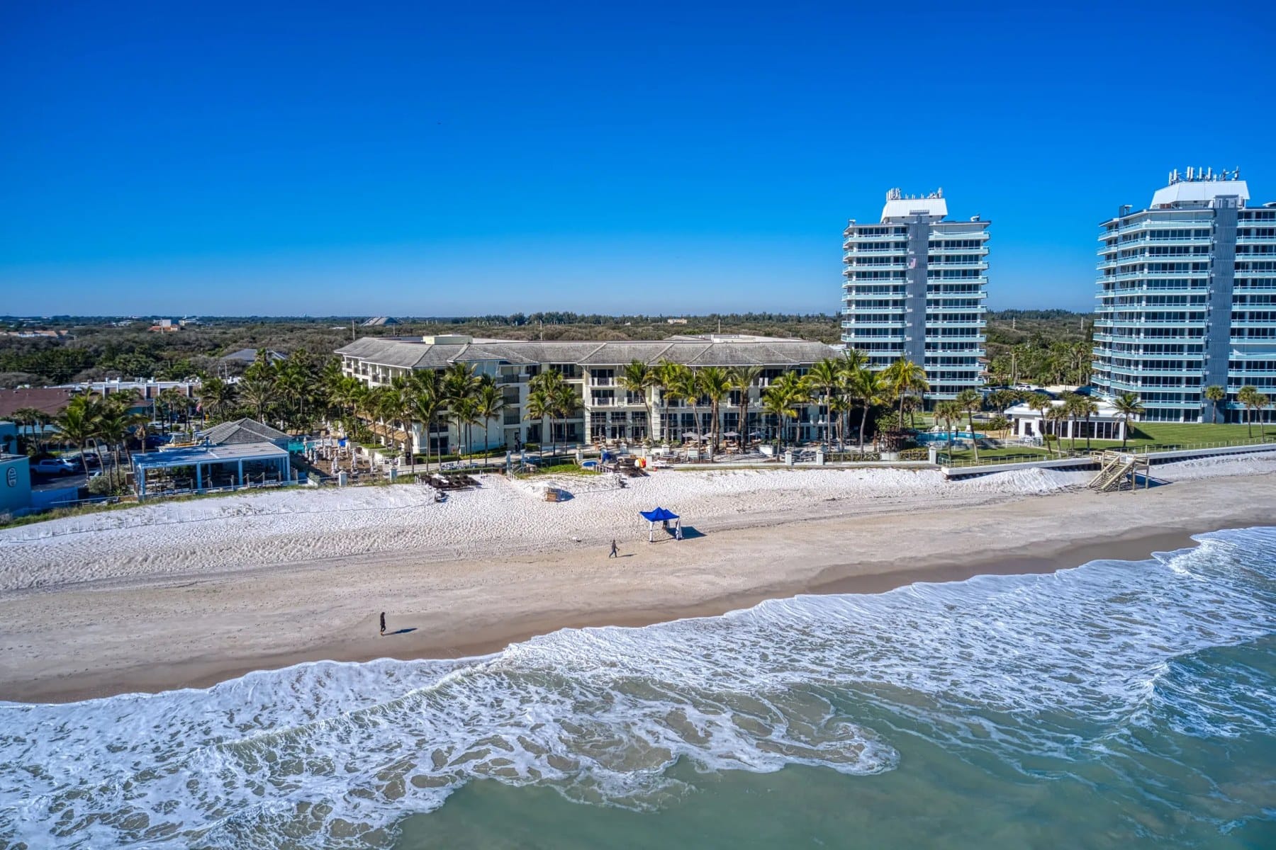 The beach in front of the Kimpton Vero Beach with waves breaking on pale sand