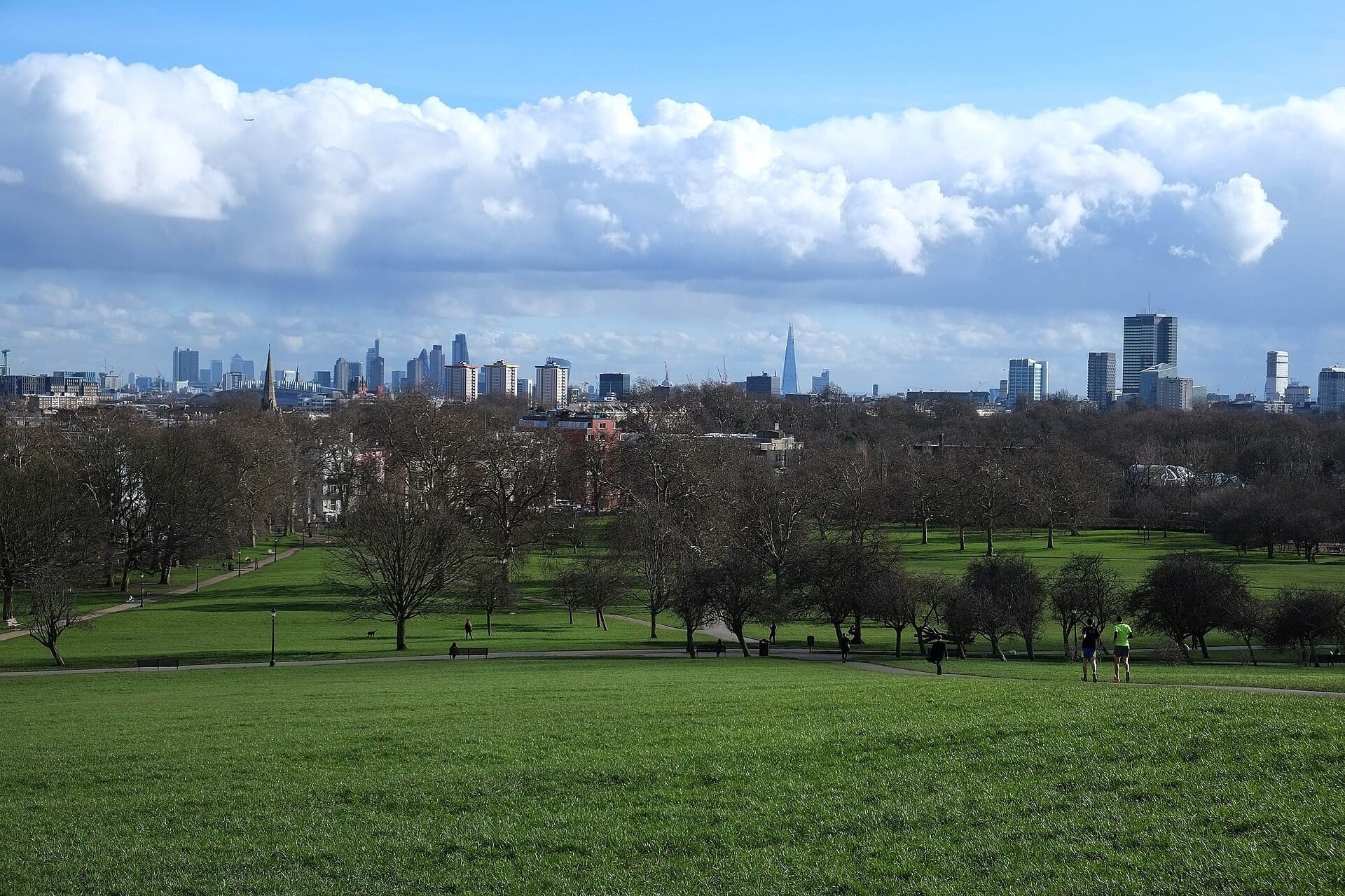 The view from Primrose Hill across the trees of Regent's Park to the London skyline and the Shard