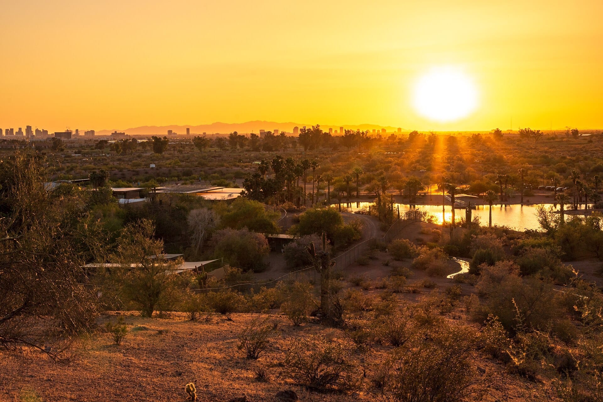 Sunset over the ponds and desert of Papago Park, with the Phoenix skyline in the distance