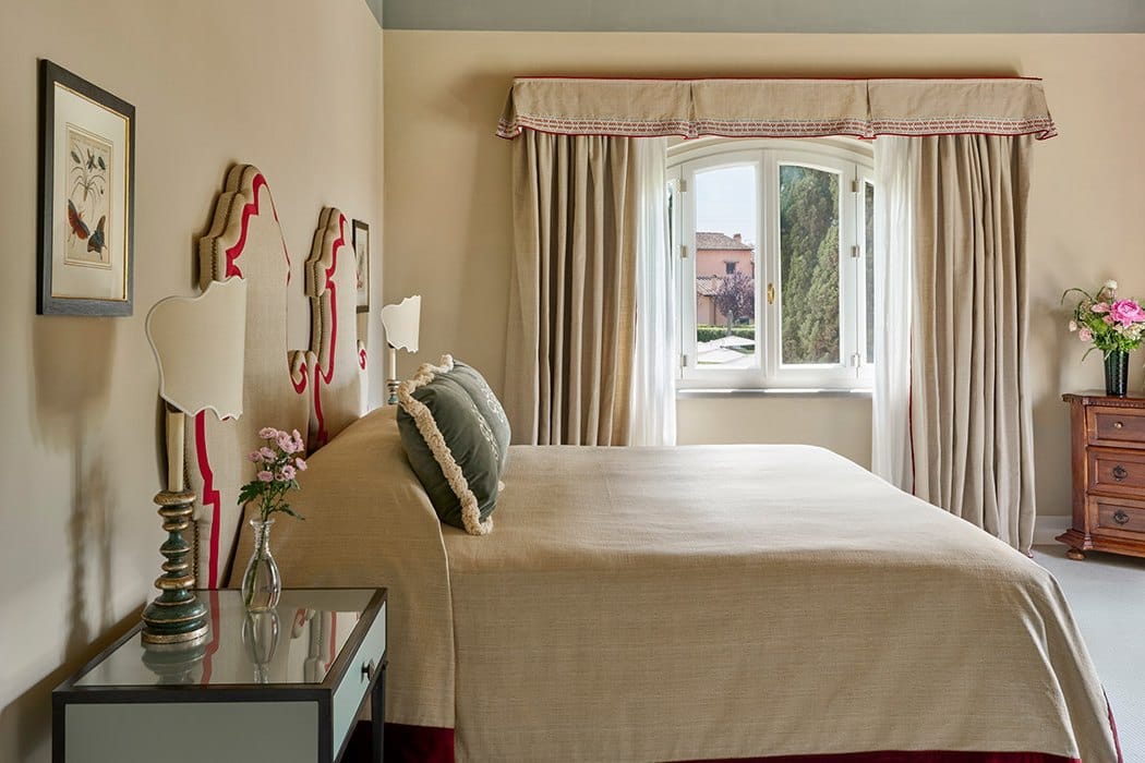 A Prestige Room at Villa La Massa with a carved headboard and a window over the gardens