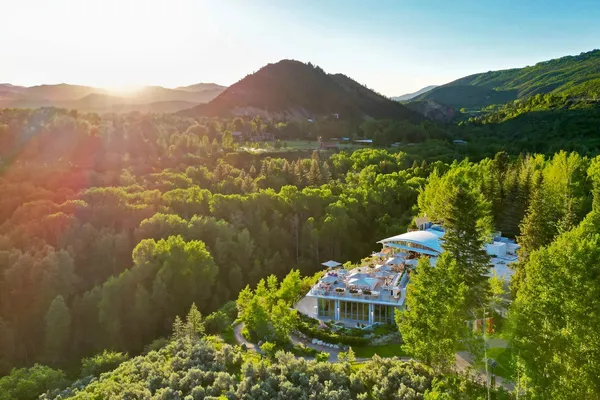 Aerial view of Aspen Meadows Resort among the trees of the Roaring Fork Valley at sunrise