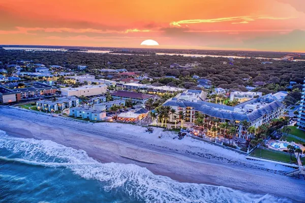 Aerial view of the Kimpton Vero Beach Hotel and Spa on the Atlantic shore at sunset